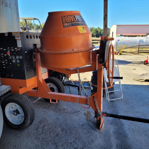 An orange concrete mixer on wheels, labeled 